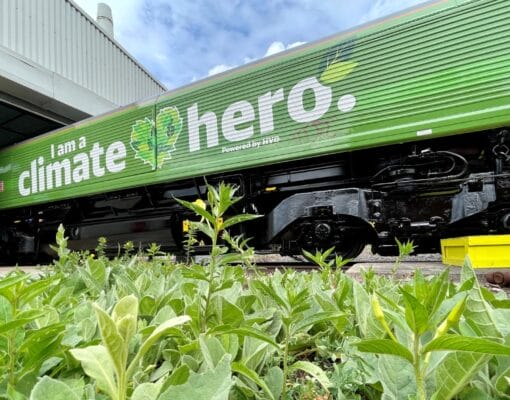 A large green train with 'I am a climate hero' written on the side