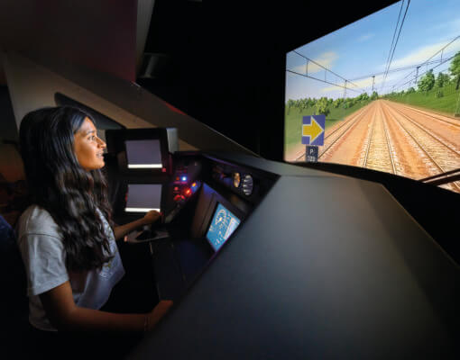 Young woman in train driving simulator