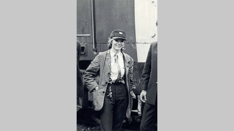 A black and white photo of Karen Harrison woman wearing a train driver uniform