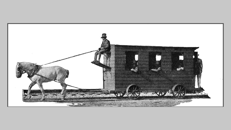 An early victorian horse-drawn railway carriage with its passengers