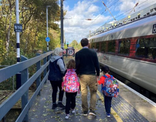 Grandparents day out with grandchildren on a station platform about to board a train