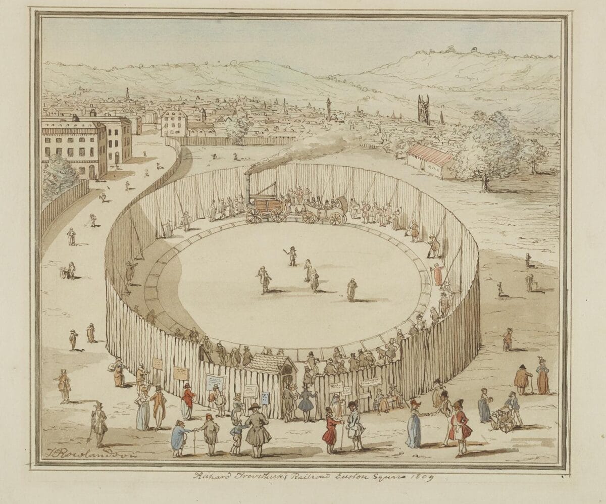 Depicts the circular enclosure and crowds enjoying a demonstration of Richard Trevithick's steam rail locomotive "Catch Me Who Can" at Euston Square, London.