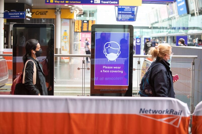 people socially distancing whilst at a train station