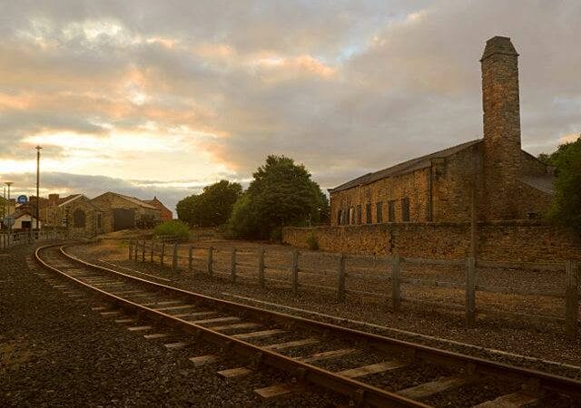 A photo of a train track and shed