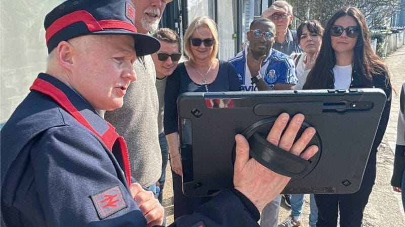 Man with tablet leading a guided walk