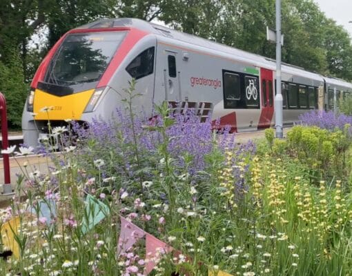 A Greater Anglia train passes through Westerfield station
