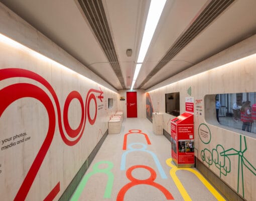 The inside of a train carriage with 200 in red on the interior wall