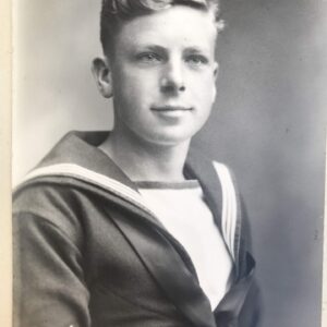 A black and white photograph of a boy smiling